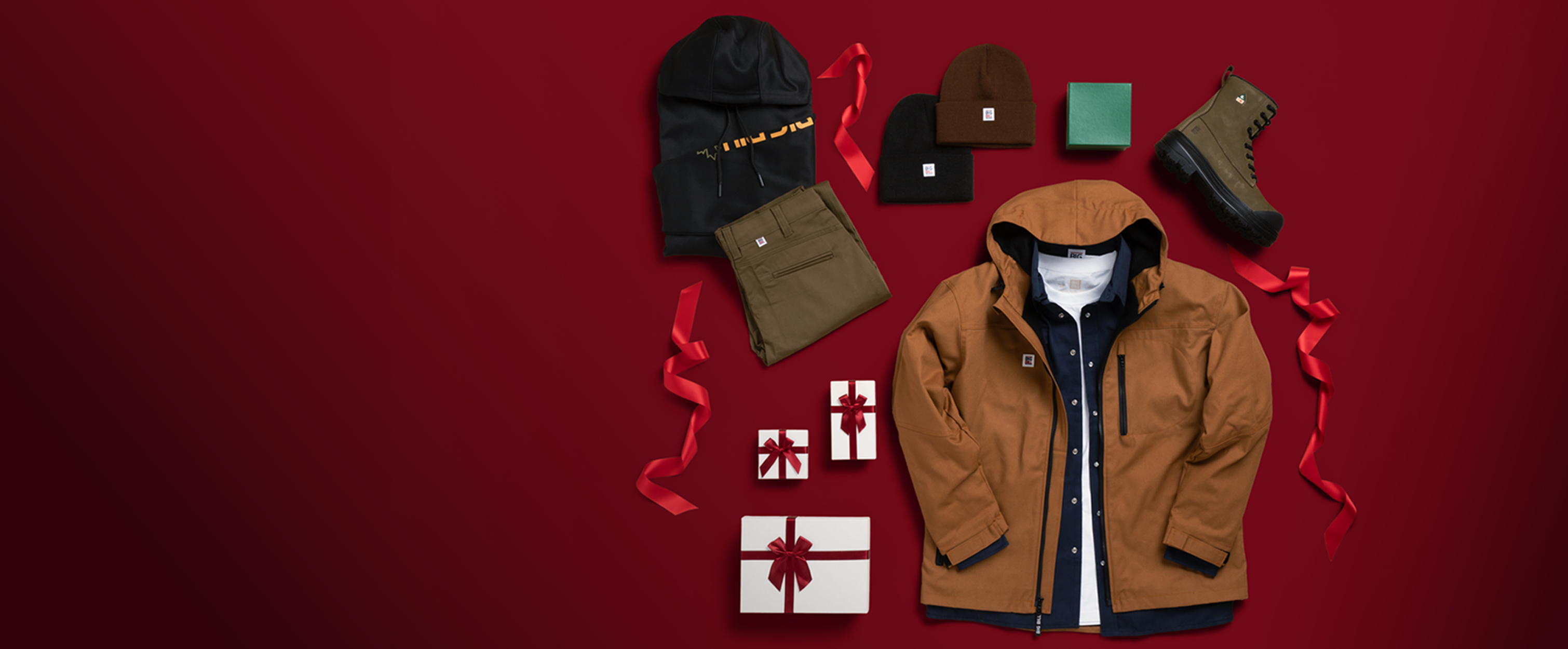 Collection of winter clothing and accessories on a red background